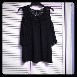 Black open-shoulder blouse.